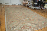 Jijim hand woven carpet corner, geometric diamonds, checkered motif in soft brick red, sea foam green.