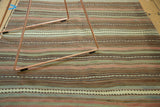 Hand woven Turkish Kilim rug detail, showing ivory, sea foam green, bronze, and blush stripes.