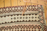 Hand-woven Turkish Kilim rug, geometric crab motifs and striped patterns in blush, ivory, charcoal.