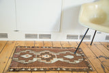 Vintage Turkish Kilim rug with triple stepped medallion and geometric patterns in bronze and orange.
