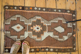 Vintage Turkish Kilim rug with geometric stepped medallion in bronze, grey, and tangerine.