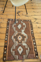 Close-up of stepped geometric motifs and reciprocating border on vintage Kilim rug.