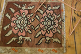 Close-up of hand woven Turkish Kilim rug featuring blush, sea foam, and bronze floral vinery.