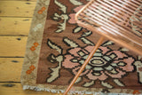 Hand woven texture of the Turkish Kilim rug with blush and pale sea foam floral vinery.