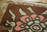 Hand-woven vintage Kilim's geometric floral motif in brown, blush, and sea foam hues.
