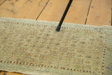 Vintage Turkish Jijim rug detail showing linear geometric pattern with soft pistachio and ivory hues.