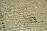 Textured hand woven geometric patterns in muted greens and ivory on a Vintage Jijim rug.