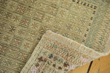 Vintage Jijim rug with hand-woven backing, natural fringe, and pistachio geometric pile.