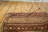Irregularly woven Turkish kilim with geometric bands and crab motifs in burgundy, blush, and brown.