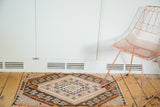 Geometric diamond patterns on a vintage Turkish Kilim rug in plum blush, ivory, and earthy tones.