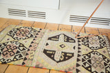 Dark charcoal quatrefoil medallion with S-motifs, blush mauve, ivory, and pale green crab designs.
