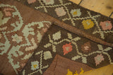 Handwoven Turkish Kilim edge with irregular flatweave, blush, green, yellow floral motifs.