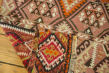 Hand woven paneled patterns in plum, red, and beige on a vintage Turkish Kilim.
