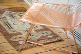Vintage Turkish Kilim rug corner showing unique wave border design in brown and sand.