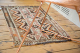 Geometric zigzag and triangular patterns on a vintage 1940s Turkish Kilim rug in brown, ivory, tangerine orange.