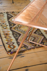 Irregular hand-woven geometric village Kilim pattern with blush pink and charcoal brown.