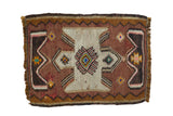 Vintage Turkish Kilim rug with hourglass medallion, geometric zigzag border, and colorful accents.