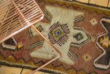 Reciprocating geometric zigzag border in brown, sand, and blush on vintage Turkish kilim.