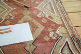 Textured weave of vintage Turkish Kilim rug with madder red, beige, and floral motifs.