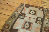Vintage Kilim rug's irregular geometric double quatrefoil pattern and floral border.