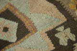 Vintage Kilim rug's slightly irregular hand-woven texture featuring blush pink, ivory, brown geometry.