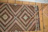 Vintage Kilim rug with blush, sand, and brown geometric diamond medallions and serpent border.