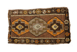 Vintage Turkish Kilim rug with geometric stepped medallions, chocolate brown and tangerine colors.