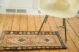 Blush peach vintage Turkish Kilim rug with double crab medallions and wave motif border.