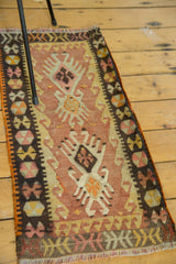 Vintage Turkish Kilim detail with blush peach field, geometric crab motif, and charcoal pinwheel border.