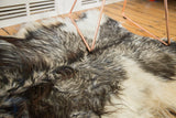 Soft, luxurious Angora skin rug detail showing ivory, silver, grey, and charcoal fur.