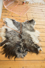Soft Angora pelt rug detail, featuring rich charcoal, grey, and ivory fur.