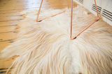 Soft ivory Angora skin rug fur featuring reddish-brown color variations.