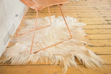 Luxurious angora skin rug with soft, long ivory and reddish-brown hair texture.