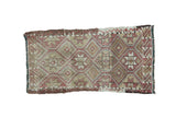Vintage Jijim rug with repeating geometric patterns in faded red, sand, and ivory, 1'4