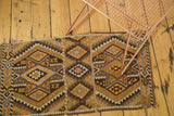 Geometric Turkish Kilim rug with paneled diamond patterns in rich brown, orange, and ivory.
