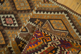 Folded corner of a hand-woven vintage Kilim rug, showing geometric patterns and vibrant reverse.
