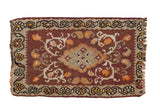Vintage Turkish Kilim rug with central medallion, floral motifs in wine red, beige, and tangerine.