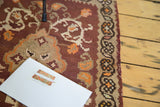 Close-up of vintage Turkish kilim rug featuring floral renderings and scrolling tendrils.
