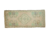 Mid-century vintage distressed Oushak runner, stepped medallion in pastel peach, celadon green.