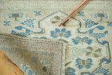 Hand-knotted construction of a vintage Oushak rug, showing reverse weave, secured side, and teal patterns.