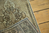 Angled view of vintage Turkish Oushak rug pile and its hand-knotted foundation.