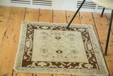 Geometric border and central pattern of a vintage Oushak rug in sand, brown, and celadon.