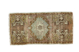 Vintage Oushak runner featuring ornate pale blue medallion, germinating planter motifs, and earthen tones.