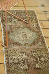 Corner of hand-knotted vintage Oushak rug, soft mauve and green germinating planter motif.