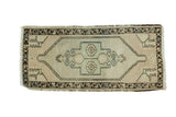 Vintage Oushak runner, blush and celadon stepped medallion, dark patterned border.
