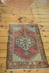 Vintage Oushak rug's short fringe and geometric border in brown, burgundy, and blue.