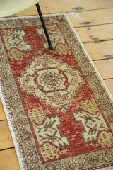 Vintage Oushak runner with distressed cherry red field, beige stepped medallion, and muted border.