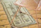 Turkish Oushak rug runner's geometric medallions, beige ground, and abrash.