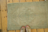 Faded celadon green vintage Oushak rug with subtle medallion pattern.