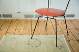 Detail of hand-knotted vintage Oushak runner, showing fringe and dark circular motif.